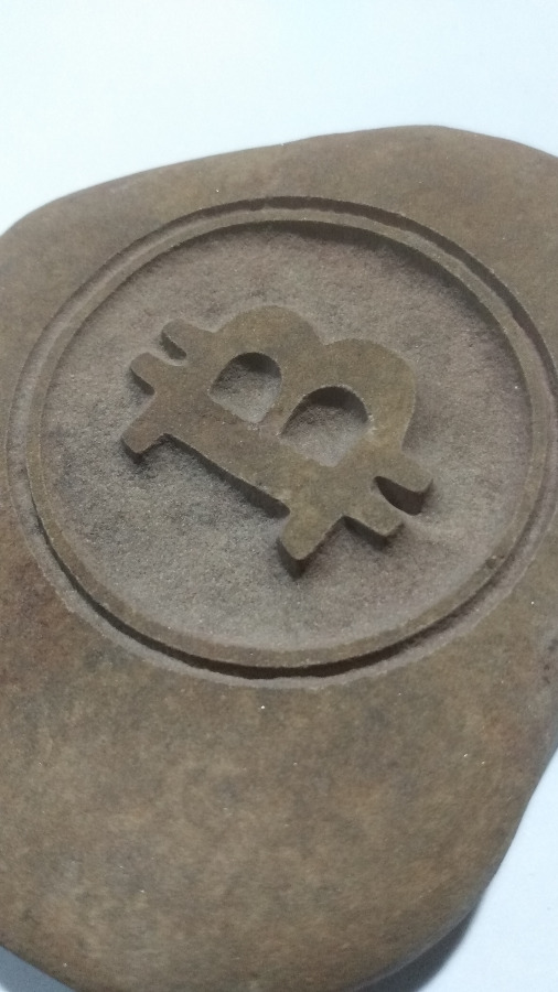 Bitcoin Symbol engraved in stone